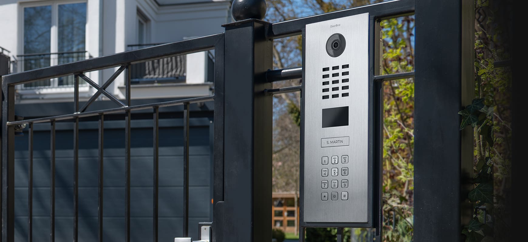 A gate with a door and a video intercom.